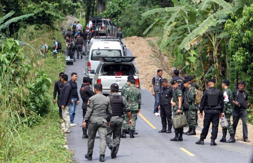 Military personnel inspect a site of an attack at Rueso district, in the troubled southern province of Narathiwat