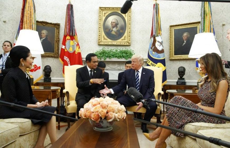 President Donald Trump shakes hands with Thai Prime Minister Prayuth Chan-ocha as his wife Naraporn Chan-ocha, left, and first lady Melania Trump watch during a meeting in the Oval Office of the White House, Monday, Oct. 2, 2017, in Washington. (AP Photo/Evan Vucci)