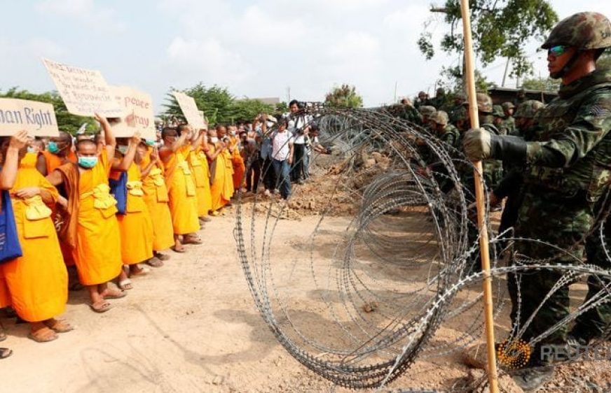 ពុទ្ធសាសនិករាប់ពាន់នៅវត្តធម្មកាយ បានបិទផ្លូវមិនឲ្យតម្រួតចូល​ទៅចាប់ខ្លួនអតីតចៅ​អធិការ​វត្តនេះ (រូបភាព​ពី​ទីភ្នាក់​ងារ​ Reuters)