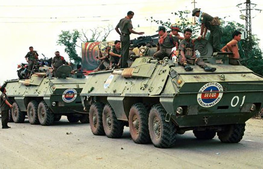 Cambodian government soldiers ride armoured personnel carriers along a street in Phnom Penh on July 7, 1997. (Credit to AFP/Tang Chhin Sothy)