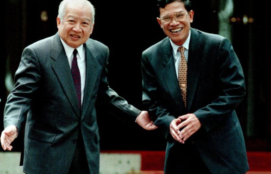 King Sihanouk (left) greets Prime Minister Hun Sen at his palace in Siem Reap City in 1997 (Reuters)