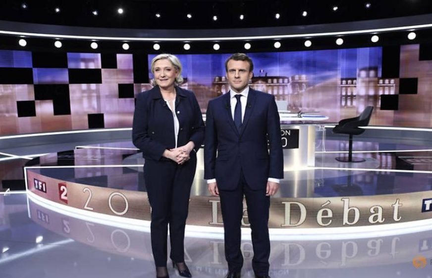 candidates-for-the-2017-presidential-election--emmanuel-macron--head-of-the-political-movement-en-marche----or-onwards----and-marine-le-pen--of-the-french-national-front--fn--party--pose-prior-to-the--4